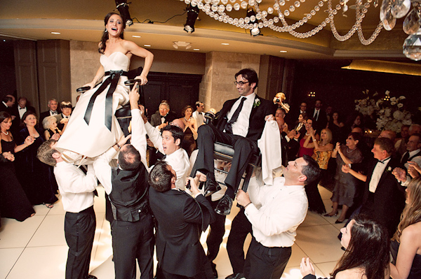 the newlywed being carried around during the reception - photo by Houston based wedding photographer Adam Nyholt